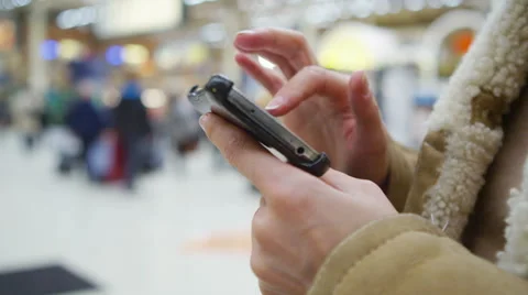 4k, Close-up of female hands using smartphone in busy train station Stock Footage 51801090