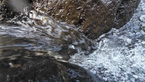 4K Close Up of Fresh River Stream Flowing Between Wet Rocks Stock Footage 336749815