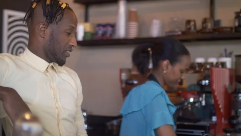 4K close up of friendly smiling workers standing behind the counter in coffee Stock Footage 111340053