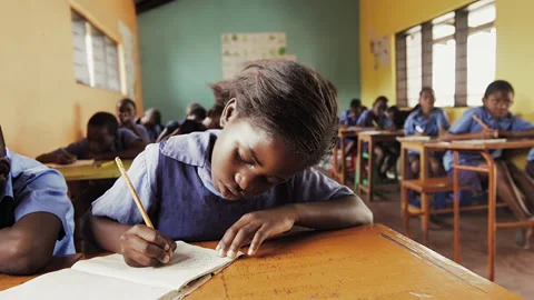 4k close front view of African students write english alphabet in notebooks in s Stock Footage 199625138