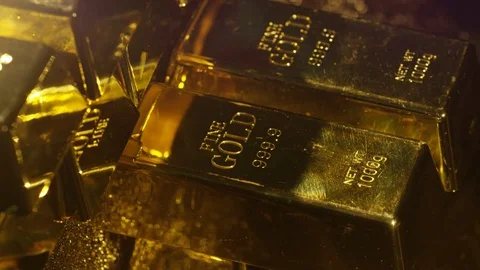 4K Close up gold bars &amp; coins on rotating stand, wealth &amp; luxury concept Stock Footage 72610583