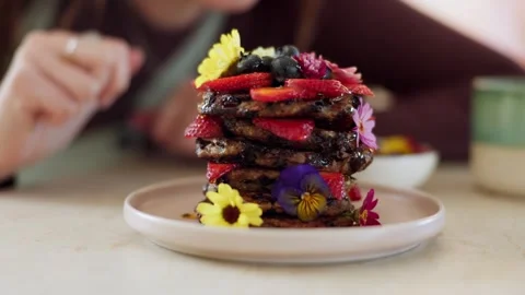 4K Close-up Gourmet Pancake Stack Garnished with Berries Edible Flower Stock Footage 330479419