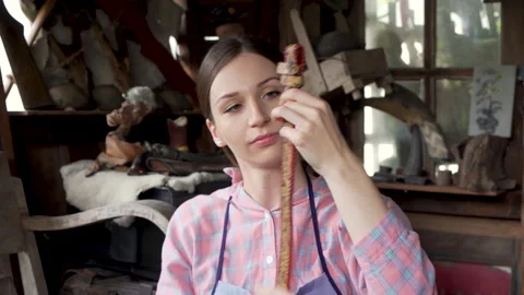 4K, close-up hand-crafted leather worker, woman sitting holding brown belt .. Stock Footage 238755078