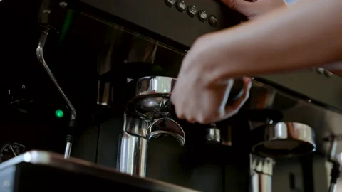 4K, Close-up hand holding coffee maker handle plugged into coffee maker, wh.. Stock Footage 232407095