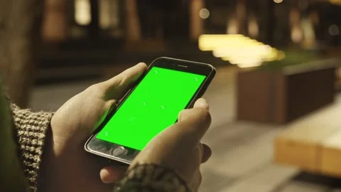 4K Close up of hand holding a smartphone with green screen display. Video stock 160104288