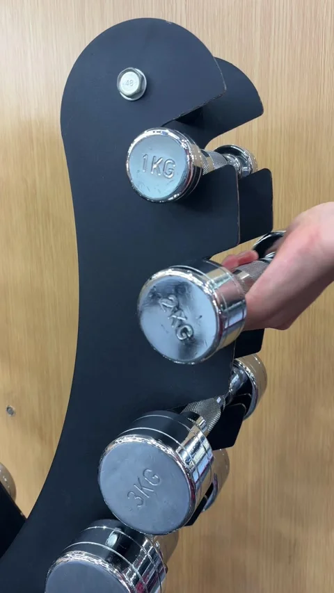 4K Close Up of Hand Returning Dumbbell to Rack Stock Footage 329336563