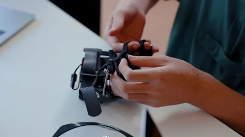 4K, Close up hand of a student trying to insert a finger into a robotic Stock Footage 232644146