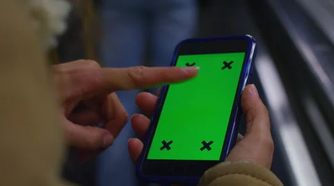 4K Close up of hand using a smartphone with green screen display Stock Footage 57253873