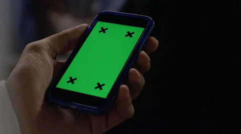 4K Close up of hand using a smartphone with green screen display Stock Footage 57255976