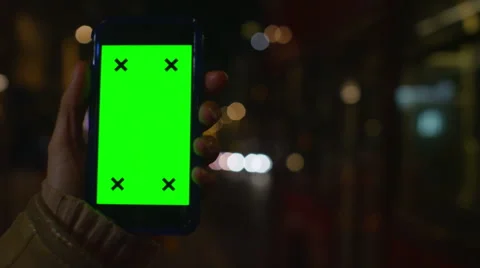 4K Close up of hand using a smartphone with green screen display outdoors Stock Footage 57285099