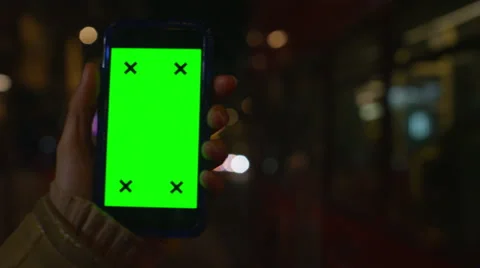 4K Close up of hand using a smartphone with green screen display outdoors Stock Footage 57286550