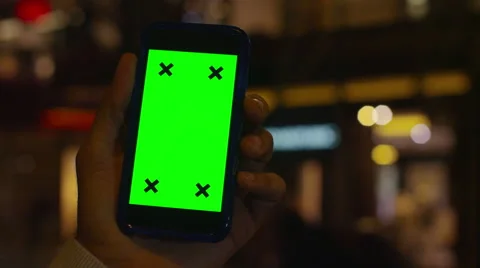 4K Close up of hand using a smartphone with green screen display outdoors Stock Footage 57287114