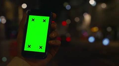4K Close up of hand using a smartphone with green screen display outdoors Stock Footage 57288064