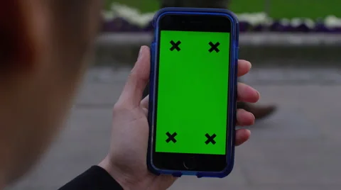 4K Close up of hand using a smartphone with green screen display outdoors Stock Footage 57291238