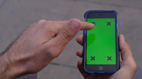 4K Close up of hand using a smartphone with green screen display outdoors Stock Footage 57291998