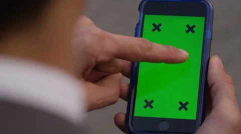 4K Close up of hand using a smartphone with green screen display outdoors Stock Footage 57292798
