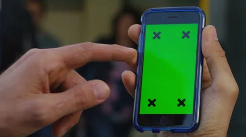 4K Close up of hand using a smartphone with green screen display outdoors Stock Footage 57297961