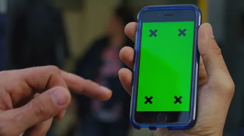 4K Close up of hand using a smartphone with green screen display outdoors Stock Footage 57298096