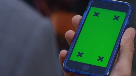 4K Close up of hand using a smartphone with green screen display outdoors Stock Footage 57299008