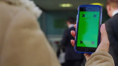 4K Close up of hand using a smartphone with green screen display outdoors Stock Footage 57300579