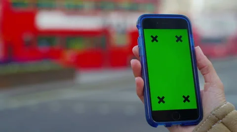 4K Close up of hand using a smartphone with green screen display outdoors Stock Footage 57301229