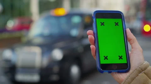 4K Close up of hand using a smartphone with green screen display outdoors Stock Footage 57301420