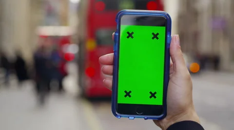 4K Close up of hand using a smartphone with green screen display outdoors Stock Footage 57303039