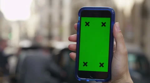 4K Close up of hand using a smartphone with green screen display outdoors Stock Footage 57304169