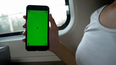 4K, Close up of hands holding and show a mock-up green screen phone in train-Dan Stock Footage 98783340