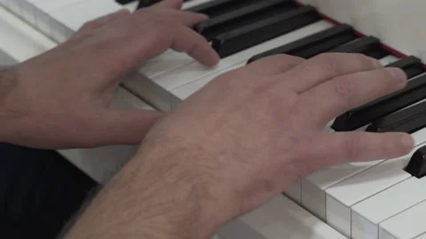 4K. Close-up of the hands of a pianist playing a musical instrument pressing. Stock Footage 164935902