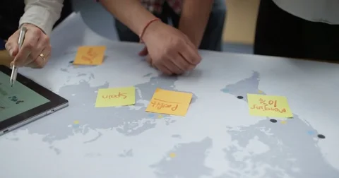 4K Close up hands of unrecognizable business team brainstorming with world map Stock Footage 76430853