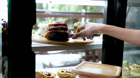4k, close-up hands unrecognizable female employee holding red velvet cake b.. 스톡 동영상 247006227