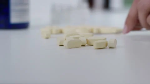 4K Close up on hands of unrecognizable pharmaceutical workers sorting tablets Stock Footage 58211013