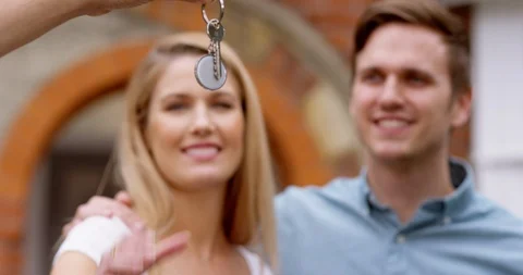4K Close up of happy couple taking key to new home &amp; walking up to front door Stock-Footage 114609489