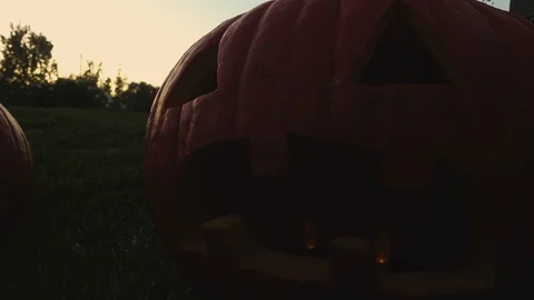 4K. Close up illuminated pumpkins inside on a dark, and scary Halloween night. Stock Footage 123525681