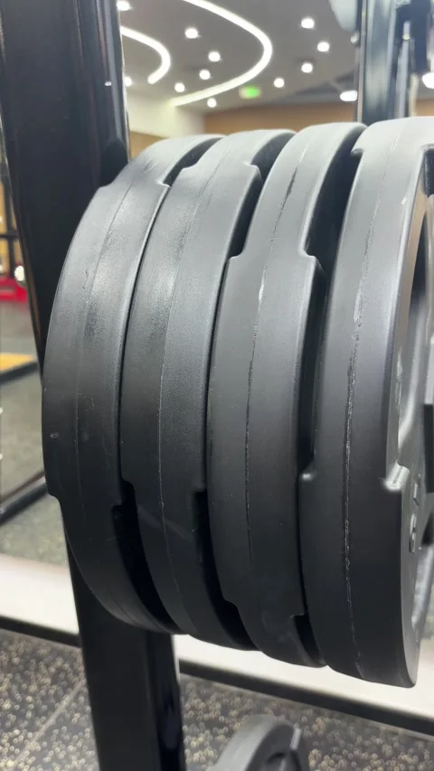 4K Close Up of Iron Weight Plates on a Metal Peg Stock Footage 329336576