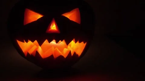4K Close-up Lit Jack-o'-lantern Eerie Glow Halloween Decoration Stock-Footage 330479714