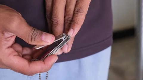 4K Close-up of a Man Cutting His Fingernails with a Stainless Steel Nail Clipper Видео 330572812