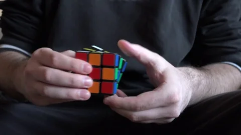 4K close up man hands playing with rubik cube solving puzzle smart people game Stock Footage 70483998