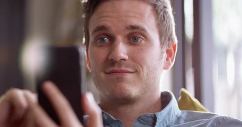 4K Close up man reading profiles on dating app &amp; swiping left &amp; right on phone Stock Footage 114752787