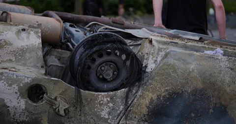 4K CLOSE UP OF MAN SITTING ON A VANDALIZED CAR AFTER PROTEST Stock Footage 131460208