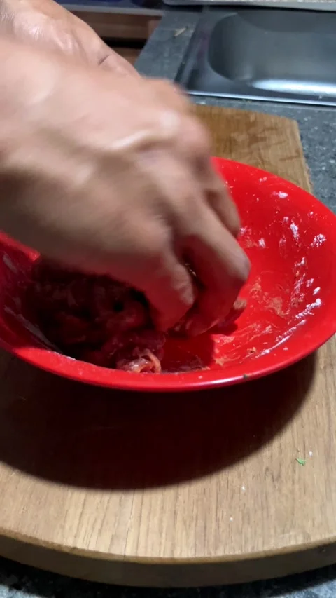 4K Close Up Of A Man's Hand Mixing Meat With Flour On A Red Bowl Stockbeeldmateriaal 337226966