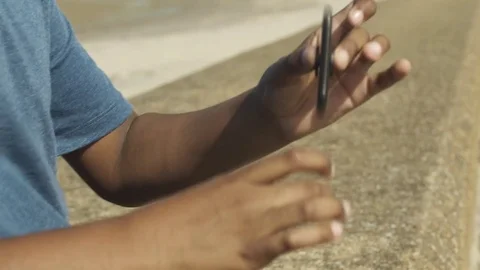 4K Close up of Mixed Race Boy Spinning Toy on Sunny Beach 库存影片 75956233