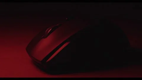 4K Close-Up of a Modern Mouse with Illuminated Details in a Dark Setting Stock Footage 221170253