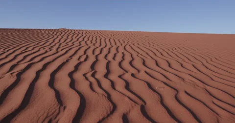 4K close-up moving shot of ripples in the surface of a sand dune Stock Footage 64710874