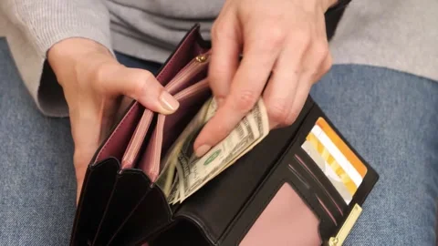 4K Close-up Person Removing US Dollar Bills from Black Leather Wallet Stock Footage 330480700