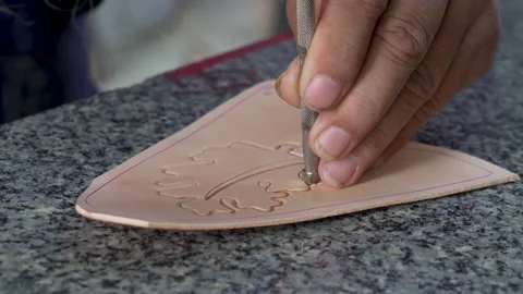 4K, Close-up piece cowhide that has been cut shape leather craftsman intend Stock Footage 237380348