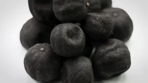 4K Close-Up Pile Black Dried Limes Loomi on White Background Stock Footage 336660304