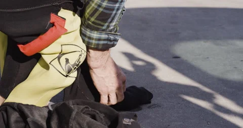 4K close up of pro surfer David Langer putting on wetsuit before going in waves Stock Footage 163075604