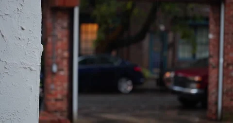 4K CLOSE UP OF RAIN FALLING WITH STREET IN BACKGROUND Stock Footage 131127181